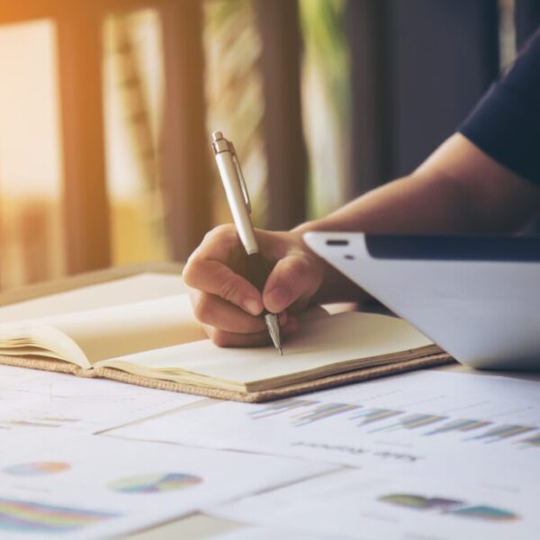 Business women signature at document. Selective focus and soft flare filter.
